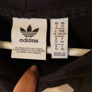 Adidas black hoodie with white logo in front.